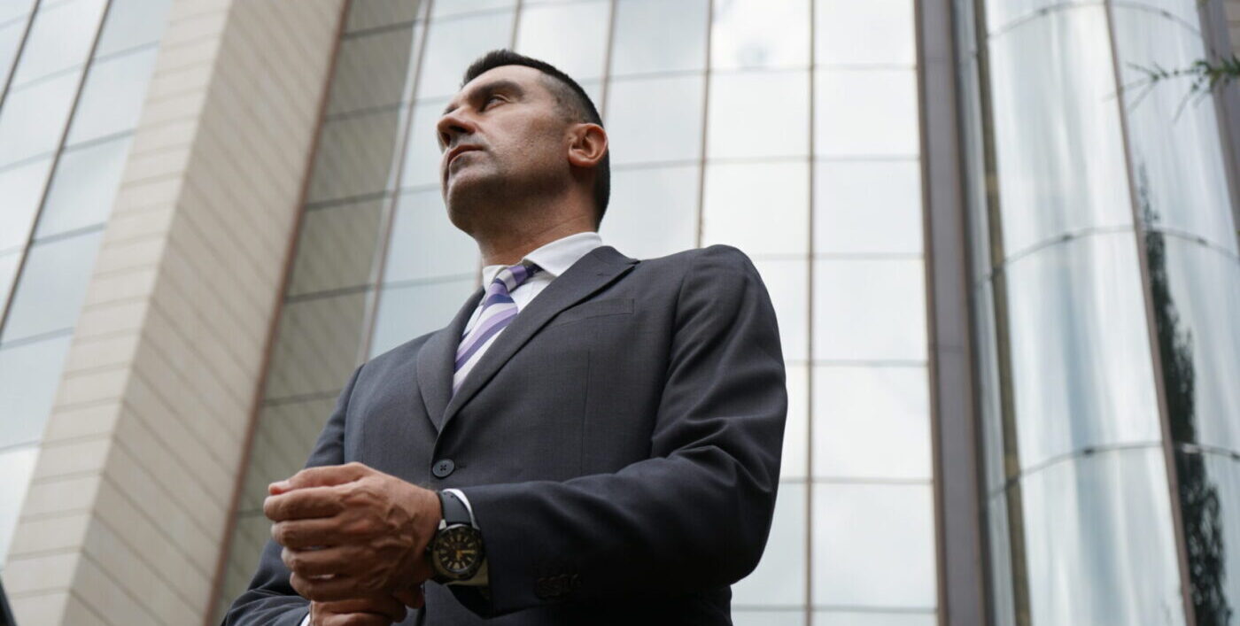 Executive employee dresses professional in front of business building