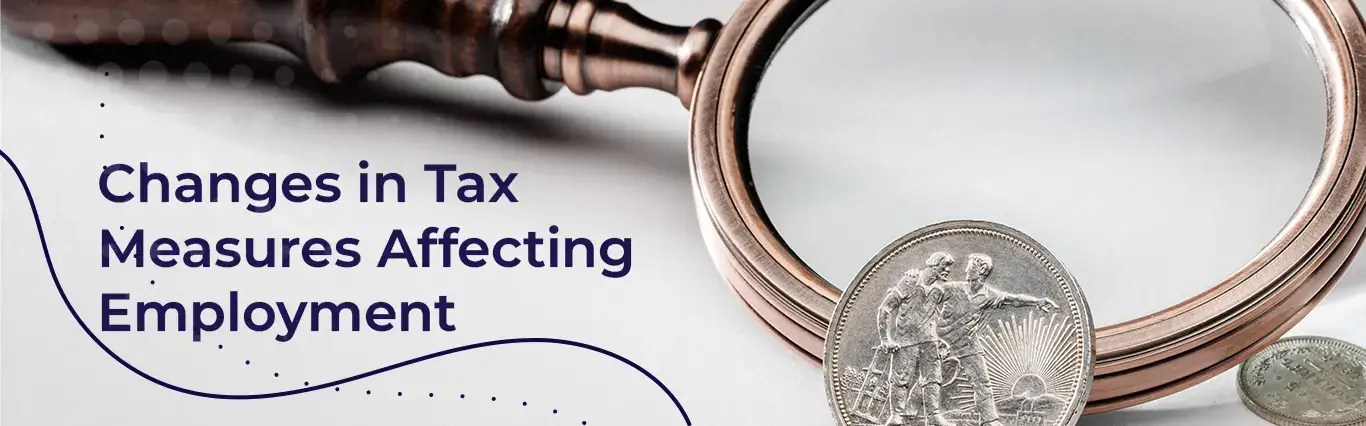 Magnifying glass focuses on coins with "Changes in Tax Measures Affecting Employment"